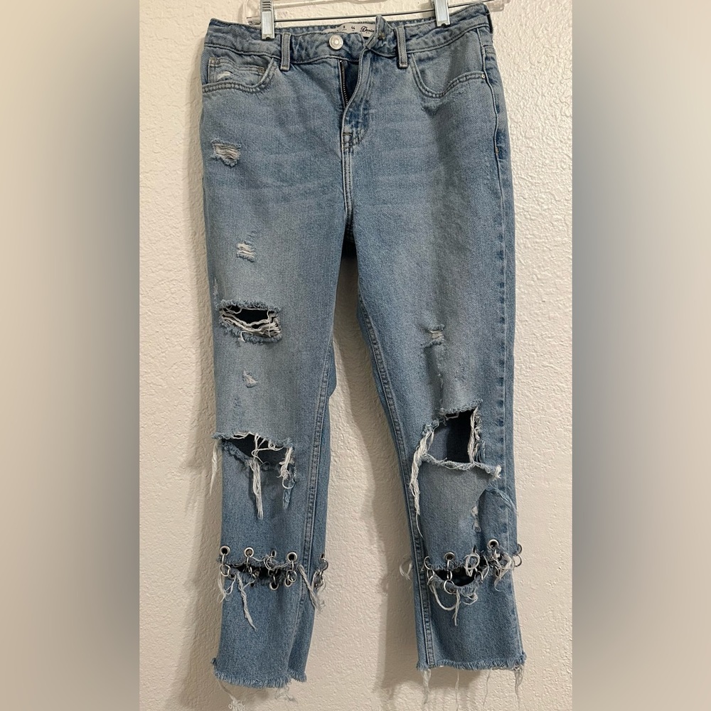 Jeans are cropped at the ankle and wide in the waist.